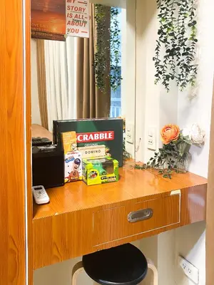 a wooden shelf with a clock and a mirror at 1BR- Axinite walking distance to MOA, PICC, SMX, Worldtrade near NAIA and Star City in Manila
