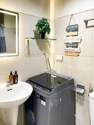 a bathroom with a sink and a trash can at 1BR- Axinite walking distance to MOA, PICC, SMX, Worldtrade near NAIA and Star City in Manila