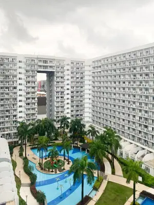 an aerial view of a large apartment complex with a swimming pool at 1BR- Axinite walking distance to MOA, PICC, SMX, Worldtrade near NAIA and Star City in Manila
