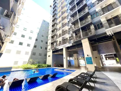 a swimming pool in the middle of a building at Suite Serenity at S residences in Manila