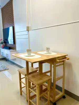 a wooden table with two cups on top of it at Suite Serenity at S residences in Manila