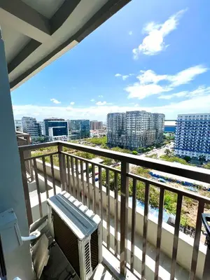 a balcony with a bench and a view of the city at Suite Serenity at S residences in Manila