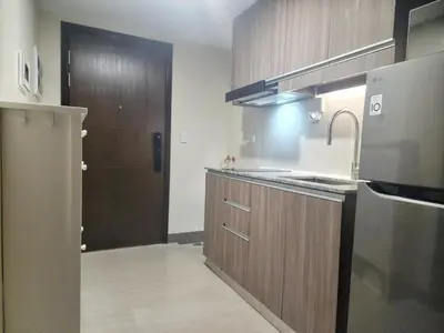 a kitchen with a sink and a stove at Your Stylish City Escape in Park Mckinley West with Breathtaking Views in Manila