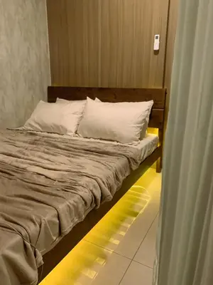 a bed with white pillows in a room at condo near MOA&NAIA&Bay, full length mirror&balcony in Manila
