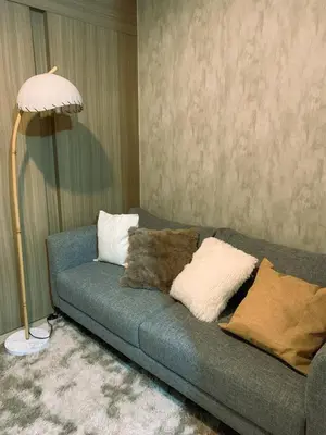 a living room with a couch with pillows and a lamp at condo near MOA&NAIA&Bay, full length mirror&balcony in Manila