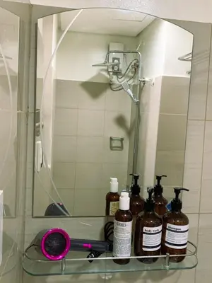 a mirror with several bottles on a shelf in a bathroom at condo near MOA&NAIA&Bay, full length mirror&balcony in Manila