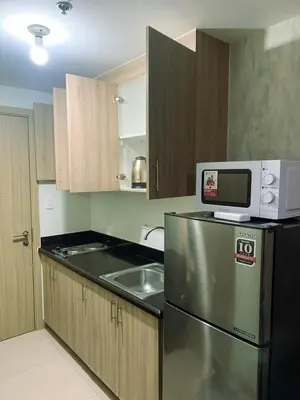 a kitchen with a microwave on top of a refrigerator at condo near MOA&NAIA&Bay, full length mirror&balcony in Manila