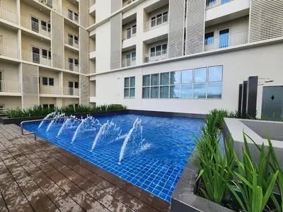 a swimming pool with a fountain in front of a building at Modern 1 br in Park Mckinley West with Breathtaking view fast internet in Manila