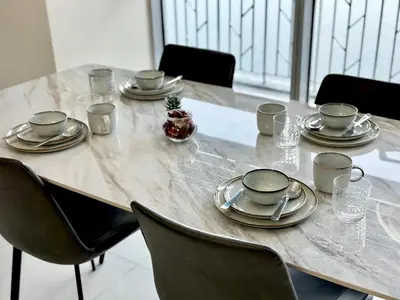 a table with plates and napkins on top of it at 2BR ManilaBay 180 Seaview Beside Okada 14 in Manila