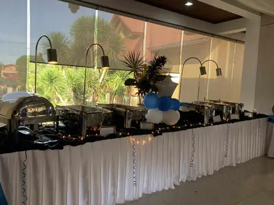 a long counter with a buffet in a room at La Traviesa Hotel Resort in General Trias