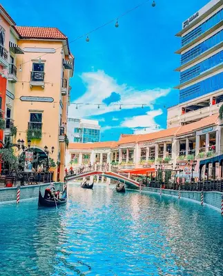 a river in a city with buildings and a bridge at Mariz Suites in Manila