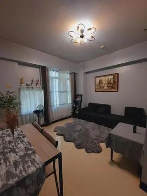 a living room with a couch and a table at Mariz Suites in Manila