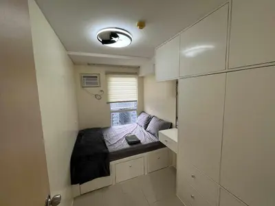 a small bedroom with a bed in a small room at Enzo vibes bnb in Manila