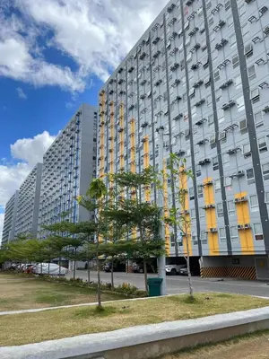 a large building with trees in front of it at Enzo vibes bnb in Manila