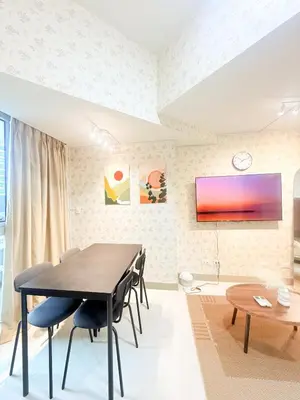 a dining room with a table and chairs at Uptown Parksuites Tower 2 in Manila