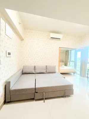 a bedroom with a bed in a room at Uptown Parksuites Tower 2 in Manila
