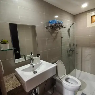 a bathroom with a sink and a toilet and a shower at Dreamy Condotel Across NAIA Terminal 3 in Manila