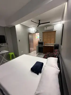 a bedroom with a large white bed in a room at Studio Room near Circuit Makati in Manila