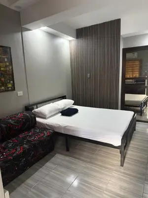 a bedroom with a large white bed in a room at Studio Room near Circuit Makati in Manila