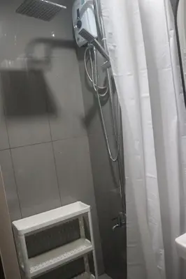 a shower in a bathroom with a glass door at Calming Haven at City Center with Netflix and Hi-Speed Wi-Fi in Manila