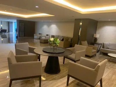 a lobby with chairs and a table with a table sidx sidx sidx at Calming Haven at City Center with Netflix and Hi-Speed Wi-Fi in Manila