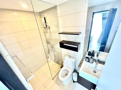 a bathroom with a shower and a toilet and a sink at Stylish Luxe Apt in Gentry Manor in Manila
