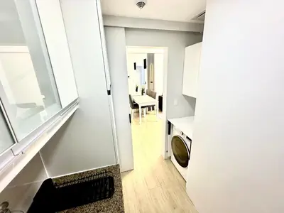 a kitchen with a sink and a window and a table at Stylish Luxe Apt in Gentry Manor in Manila