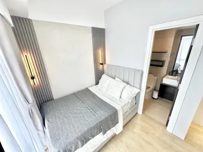 a small bedroom with a bed and a bathroom at Stylish Luxe Apt in Gentry Manor in Manila