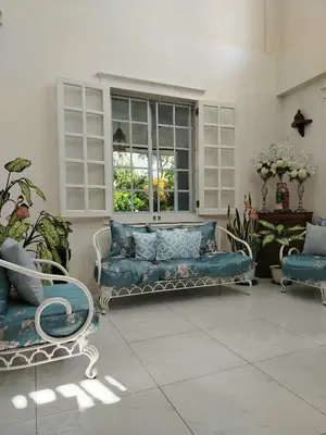 a living room with a blue couch and a window at El Casa Azul in Amadeo