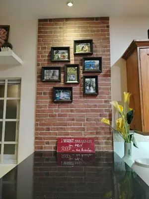 a brick wall with a sign on it at El Casa Azul in Amadeo