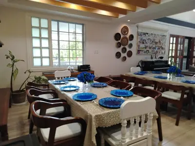 a dining room with a table with blue plates on it at El Casa Azul in Amadeo