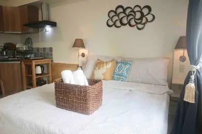 a room with a bed with baskets on it at Dreamy Studio with Netflix and High Speed Wifi in Manila