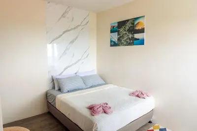 a bedroom with a bed with pink bows on it at Family-Friendly 2BR Staycation near Nuvali & Enchanted Kingdom in Puting Kahoy