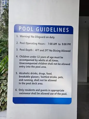 a sign that says pool guidelines on a building at The Infinity Towers in BGC - Spacious 2 Bedroom - View, Washer, Fast WiFi in Manila