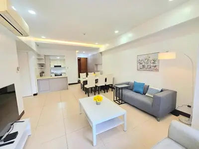 a living room with a couch and a table at The Infinity Towers in BGC - Spacious 2 Bedroom - View, Washer, Fast WiFi in Manila