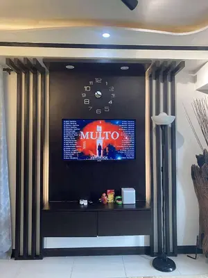 a flat screen tv on a wall in a room at JOYCE LARA Staycation in Manila