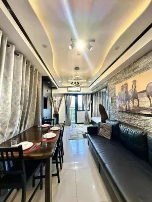 a living room with a couch and a table at JOYCE LARA Staycation in Manila