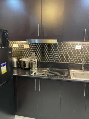 a kitchen with a sink and a counter top at JOYCE LARA Staycation in Manila
