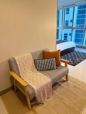 a living room with a couch and a bed at BGC 1BR with Fast wifi and Pool use in Manila