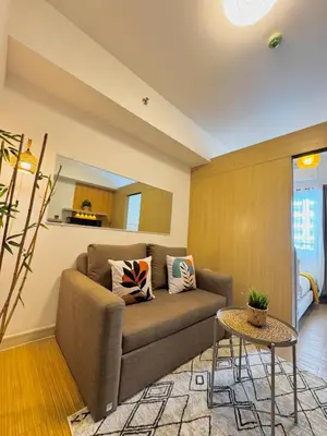 a living room with a couch and a table at Celebrity Stays in Manila