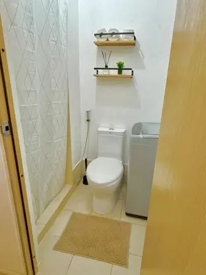 a small bathroom with a toilet and a shower at Celebrity Stays in Manila