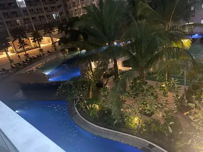 an overhead view of a swimming pool at night at Shore residence A41 shortwalk mall of asia in Manila