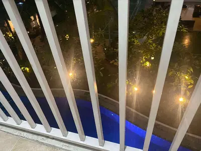 a view of a pool through a window at night at Shore residence A41 shortwalk mall of asia in Manila
