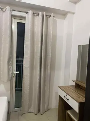 a bedroom with a window with curtains and a television at Shore residence A41 shortwalk mall of asia in Manila