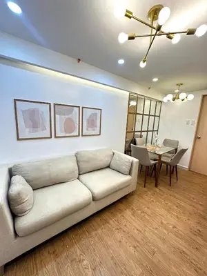 a living room with a couch and a table at Kali's Pad in Manila