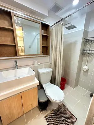 a bathroom with a white toilet and a sink at Kali's Pad in Manila