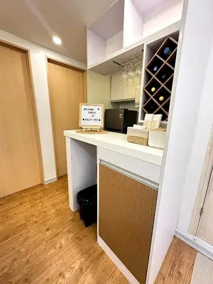 a kitchen with a counter with wine bottles at Kali's Pad in Manila