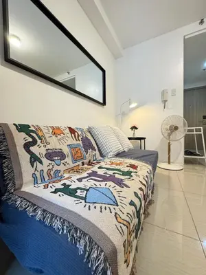a bedroom with a bed and a mirror on the wall at MOA Staycation at Shore Residences Tower C in Manila