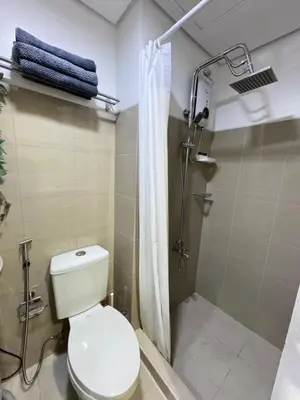 a bathroom with a toilet and a shower at MOA Staycation at Shore Residences Tower C in Manila