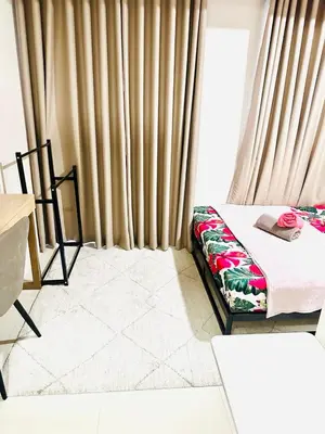 a bedroom with a bed and a window with curtains at One-bedroom condo within the city at S Residences in Manila